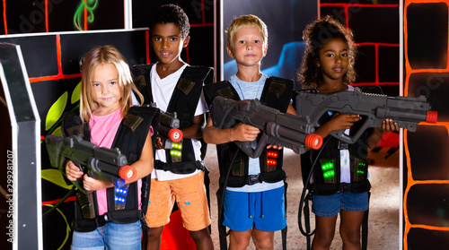 Group of cheerful tweenagers with laser guns