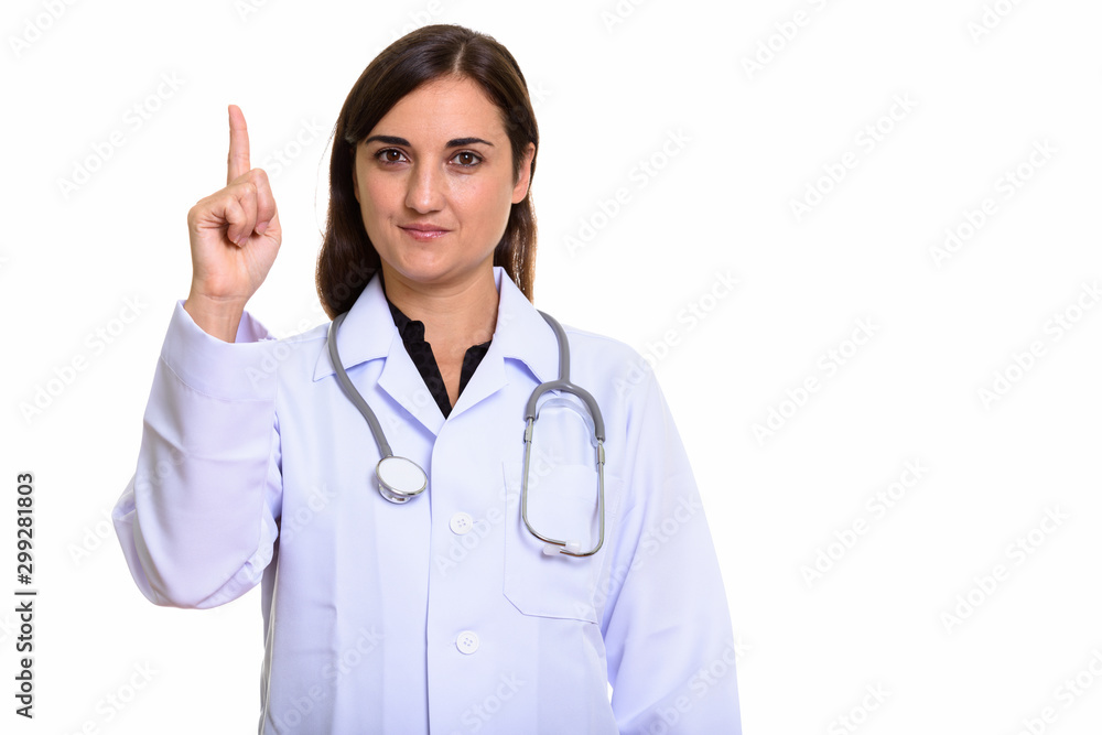 Studio shot of beautiful woman doctor pointing finger up Studio shot of beautiful woman doctor pointing finger up