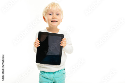 smiling charming boy with a tablet in hand screen forward on a white isolated background