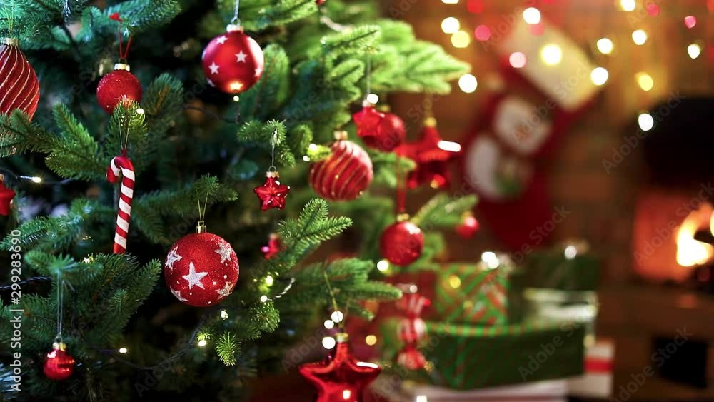 Christmas Tree with Decorations Near a Fireplace with Lights