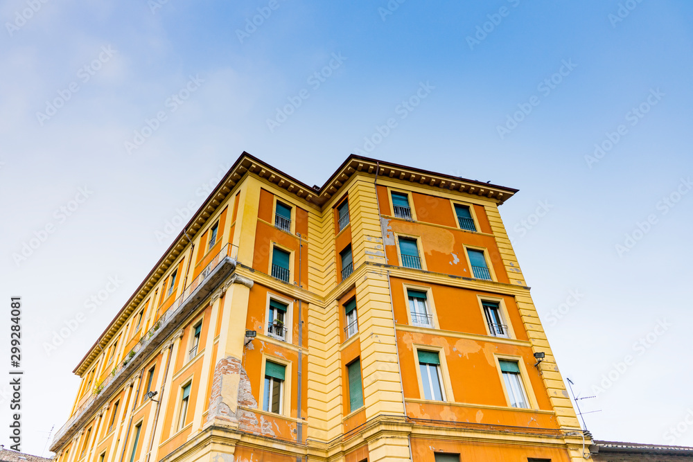 Orange building with apartments in Forli, Italy