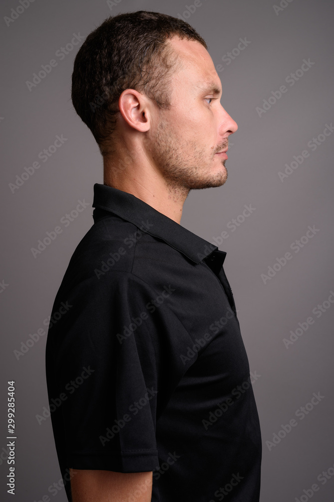 Portrait of handsome man against gray background