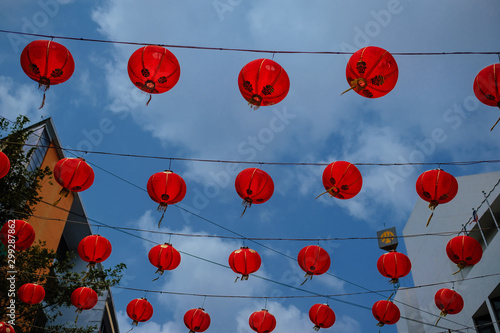 hundreds of lanterns hung across the courtyard in Chinese New Year over blue sky.