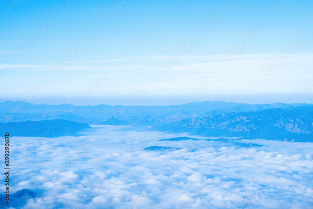 Blue sky background with white clouds at morning.Mist in the morning on the mountain.