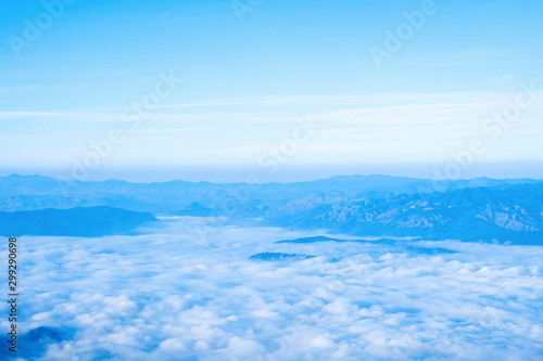 Blue sky background with white clouds at morning.Mist in the morning on the mountain.