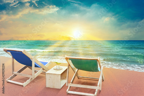 two beach chairs on sunset time and scenery sea view with beautiful sun rays , summer concept © OHishi_Foto