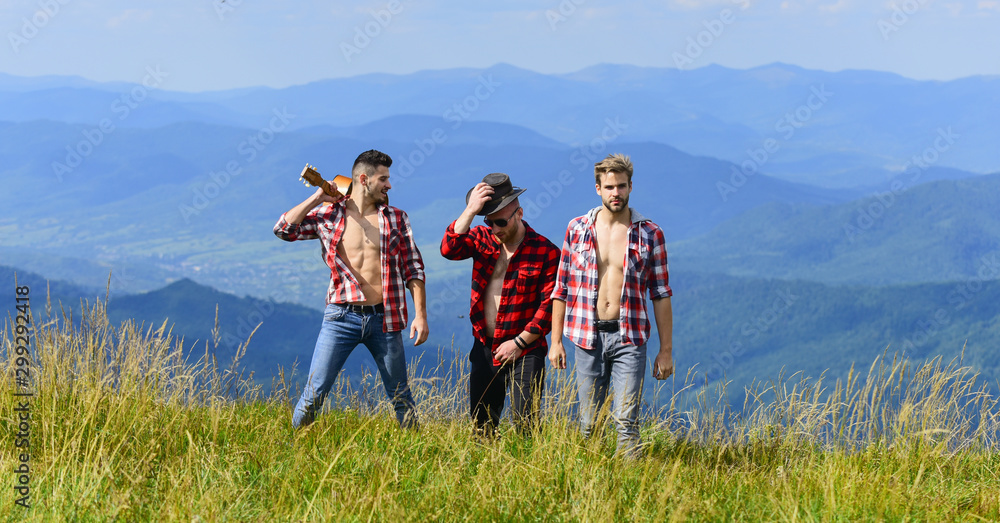 Bring music to life. people spend free time together. hiking adventure. cowboy men. western camping. campfire songs. happy men friends with guitar. friendship. men with guitar in checkered shirt