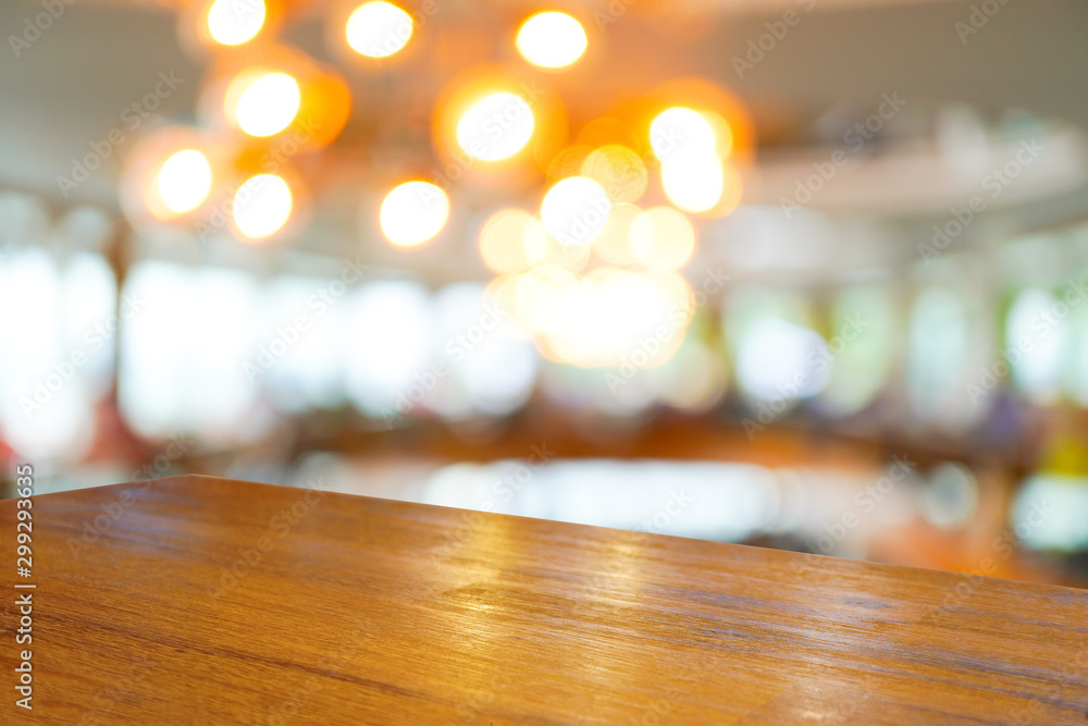 Empty wooden table top with blurred of restaurant cafe background, can be used for display or montage your products