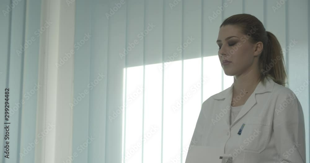 Nurse adding ECG test mature doctor cardiologist during examination of senior patient who is lying on the bed in the office room. Nurse adding ECG test mature doctor cardiologist during examination of senior patient who is lying on the bed in the office room.
