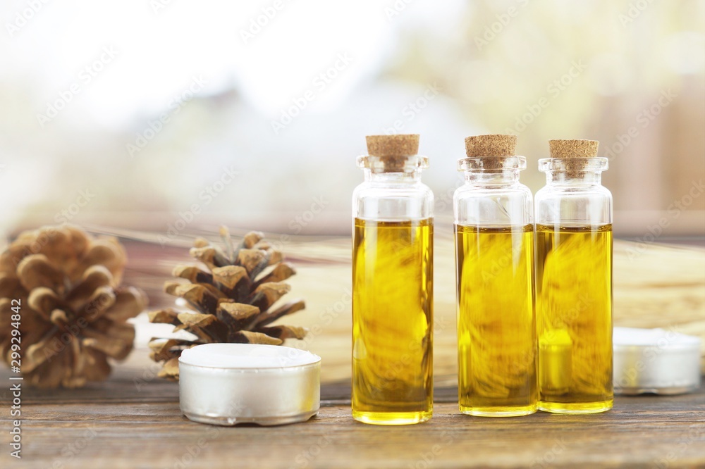 Essence of flowers and herb in a beautiful glass jar on wooden background. Essence of flowers and herb in a beautiful glass jar on wooden background.