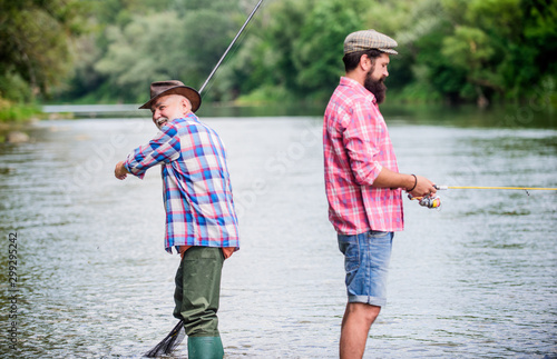 Summer weekend. Peaceful activity. Nice catch. Rod and tackle. Fisherman family. Hobby sport activity. Father and son fishing. Fisherman fishing equipment. Fisherman grandpa and mature man friends