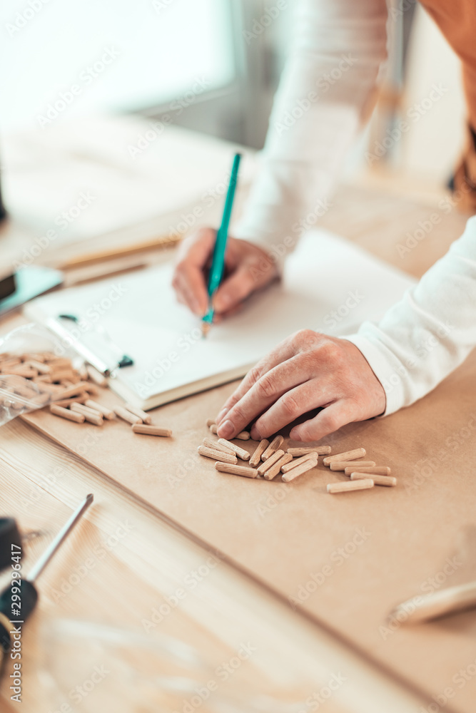 Female carpenter working with wooden dowels Female carpenter working with wooden dowels