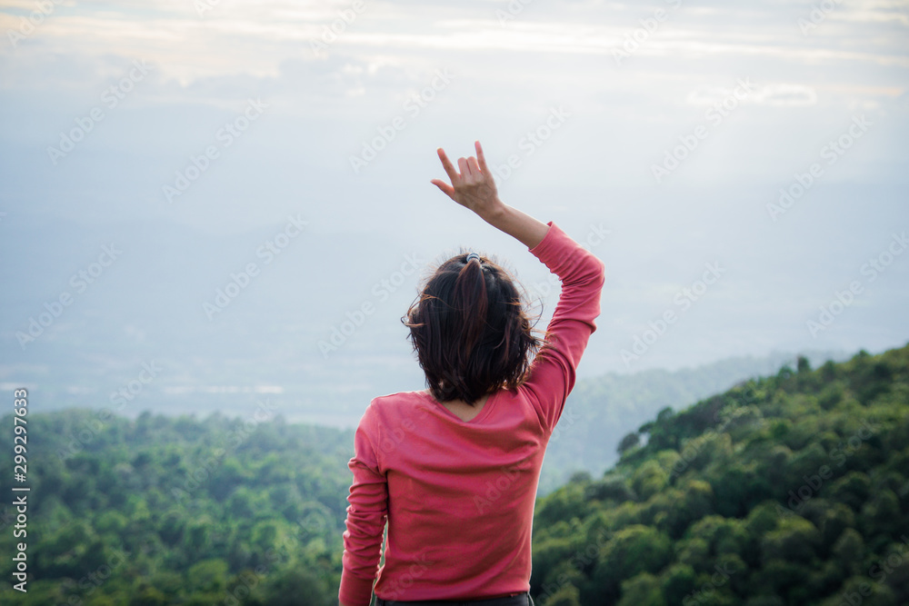 rear of happy woman stand on top mountain looking view with mist and cloud. soft focus and noise. rear of happy woman stand on top mountain looking view with mist and cloud. soft focus and noise.
