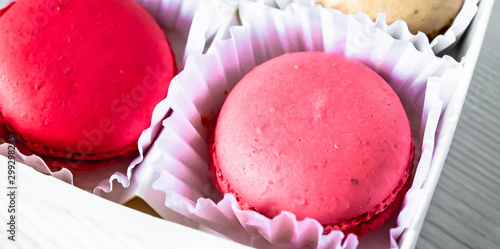 Macarons isolated on a white wooden background... photo