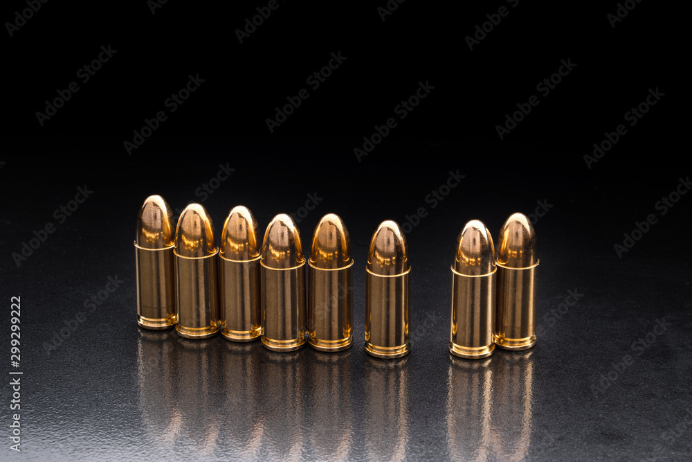 Bullet isolated on black background with reflexion. Rifle bullets close-up on black back. Cartridges for rifle and carbine on a black. Bullet isolated on black background with reflexion. Rifle bullets close-up on black back. Cartridges for rifle and carbine on a black.