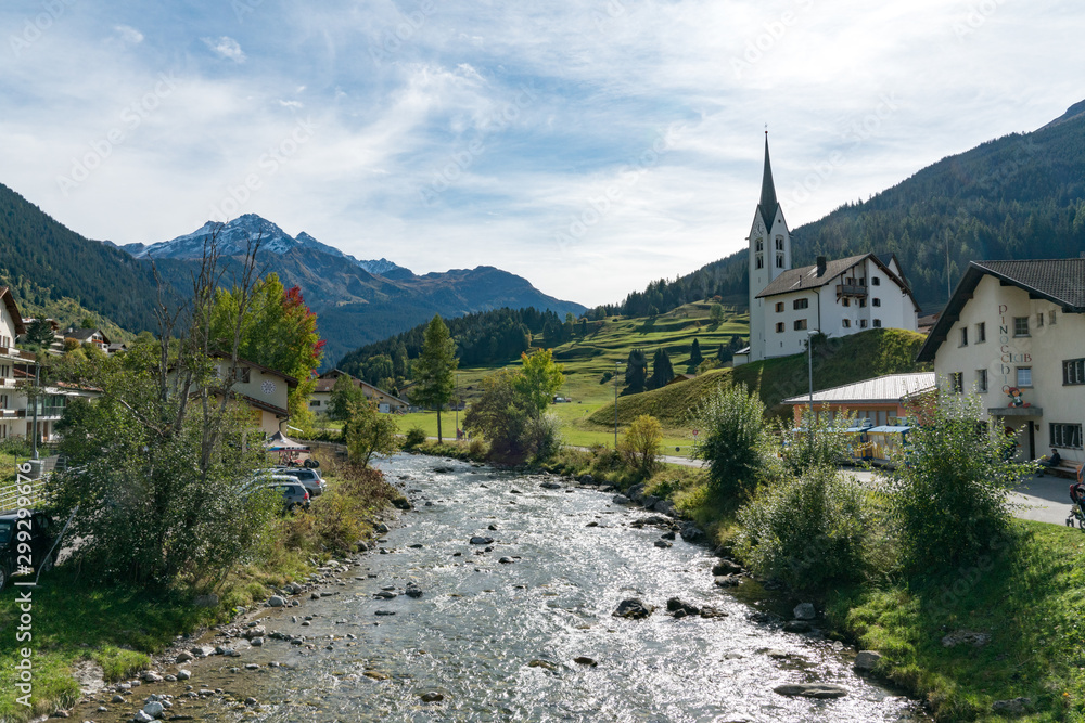view of the picturesque village and church of Savognin on the Julia River in the Swiss Alps