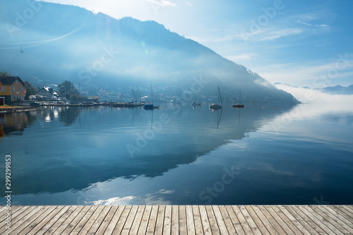 Backlit view of boats anchored at the Traunsee in Gmunden, OÖ, Austria with the Grünberg rising in the background
