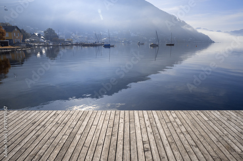 Backlit view of boats anchored at the Traunsee in Gmunden, OÖ, Austria with the Grünberg rising in the background photo