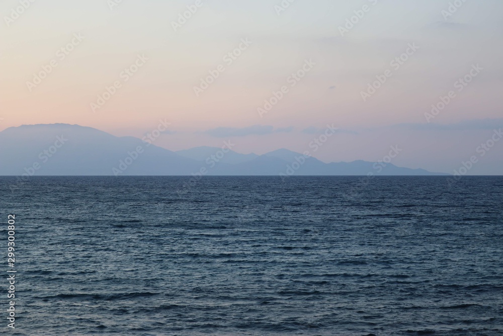 sea with mountains in the background