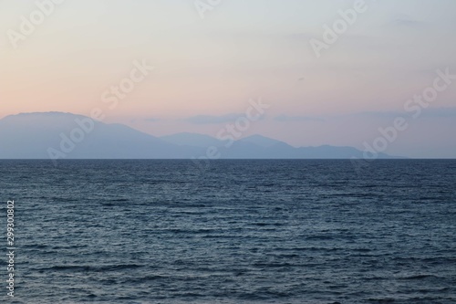 sea with mountains in the background