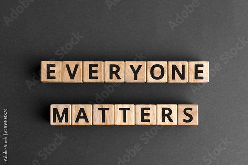 Everyone matters - phrase words from wooden blocks with letters, accepting others individuality everyone matters concept, top view gray background