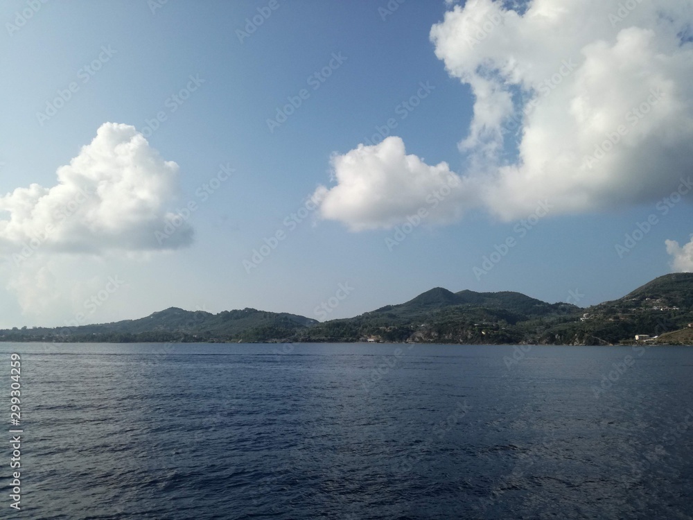 Sea and mountains with cloudy sky