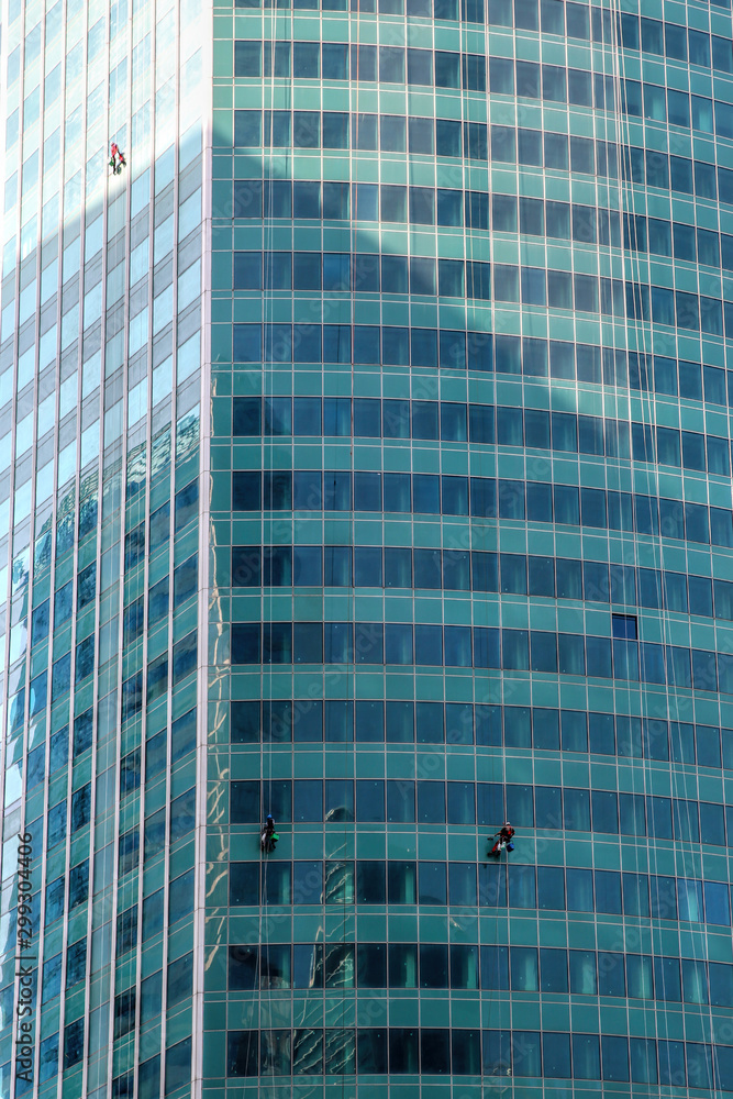 Сlimbers wash windows and glass facade of the skyscraper. Moscow city (Moscow International Business Center) , Russia Сlimbers wash windows and glass facade of the skyscraper. Moscow city (Moscow International Business Center) , Russia