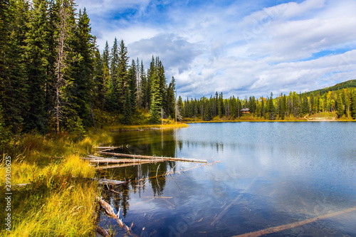 Smooth water reflects the cloudy sky