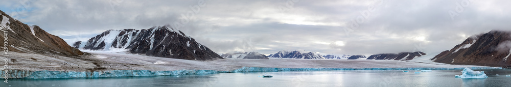 Panorama of a glacier and mountains in Ellesmere Island, part of the Qikiqtaaluk Region in the Canadian territory of Nunavut. Panorama of a glacier and mountains in Ellesmere Island, part of the Qikiqtaaluk Region in the Canadian territory of Nunavut.