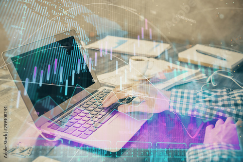 Double exposure of forex chart with man working on computer on background. Concept of market analysis. © peshkova