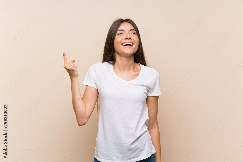 Pretty young girl over isolated background pointing up and surprised Pretty young girl over isolated background pointing up and surprised