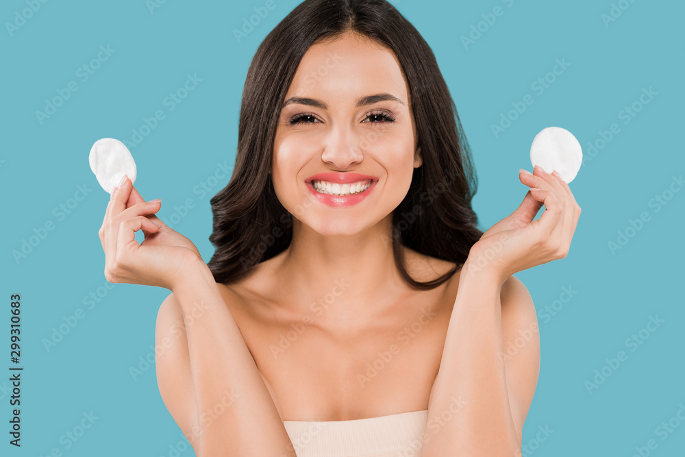 happy woman holding cotton pads isolated on blue happy woman holding cotton pads isolated on blue