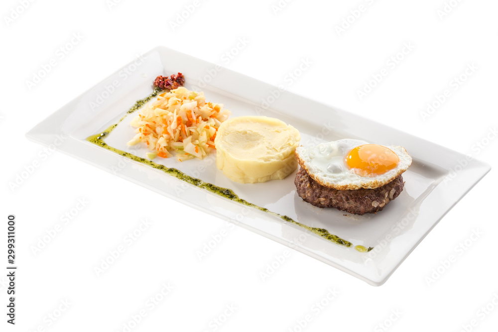 Fried egg with beefsteak, mashed potatoes and pickled cabbage on white plate isolated on white background Fried egg with beefsteak, mashed potatoes and pickled cabbage on white plate isolated on white background