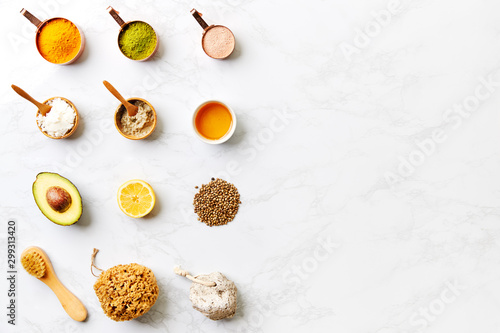 Overhead View Of Natural Beauty And Health Products In Measuring Cups On Marble Background