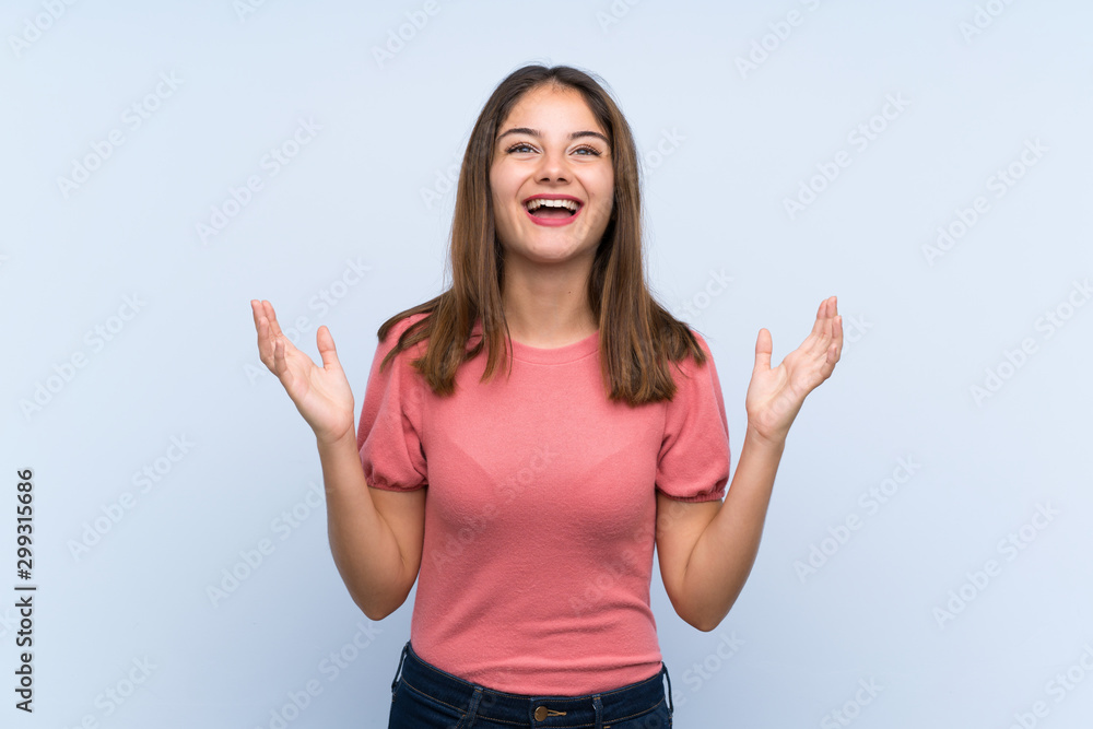 Fototapeta premium Young brunette girl over isolated blue background laughing