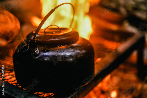 Old teapot boils on campfires