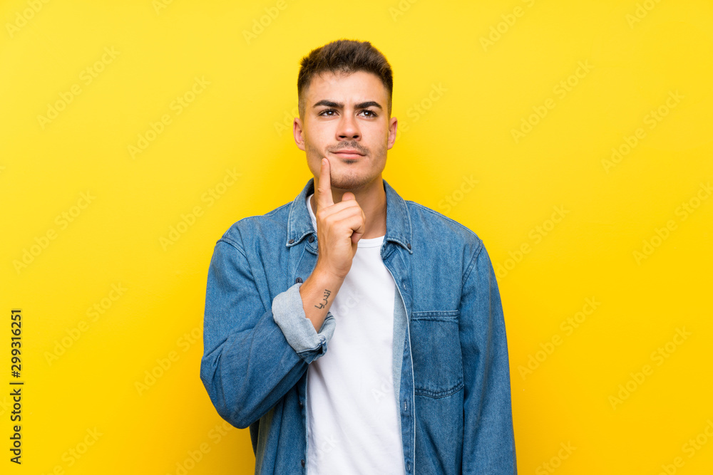 Young handsome man over isolated yellow background thinking an idea Young handsome man over isolated yellow background thinking an idea