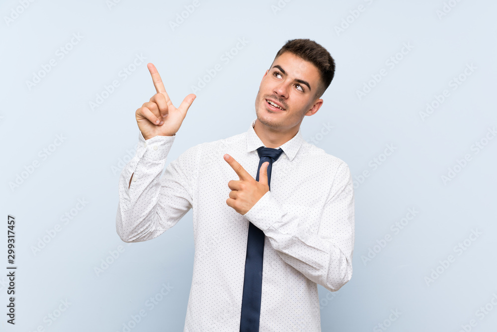 Handsome businessman over isolated blue background pointing with the index finger a great idea Handsome businessman over isolated blue background pointing with the index finger a great idea