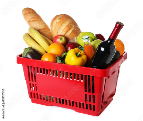 Shopping basket with grocery products on white background