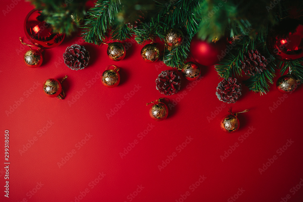 Christmas ornaments on the red background. Christmas decorations with space for text. Fir-cones, balls and christmas tree isolated. Christmas greeting card.