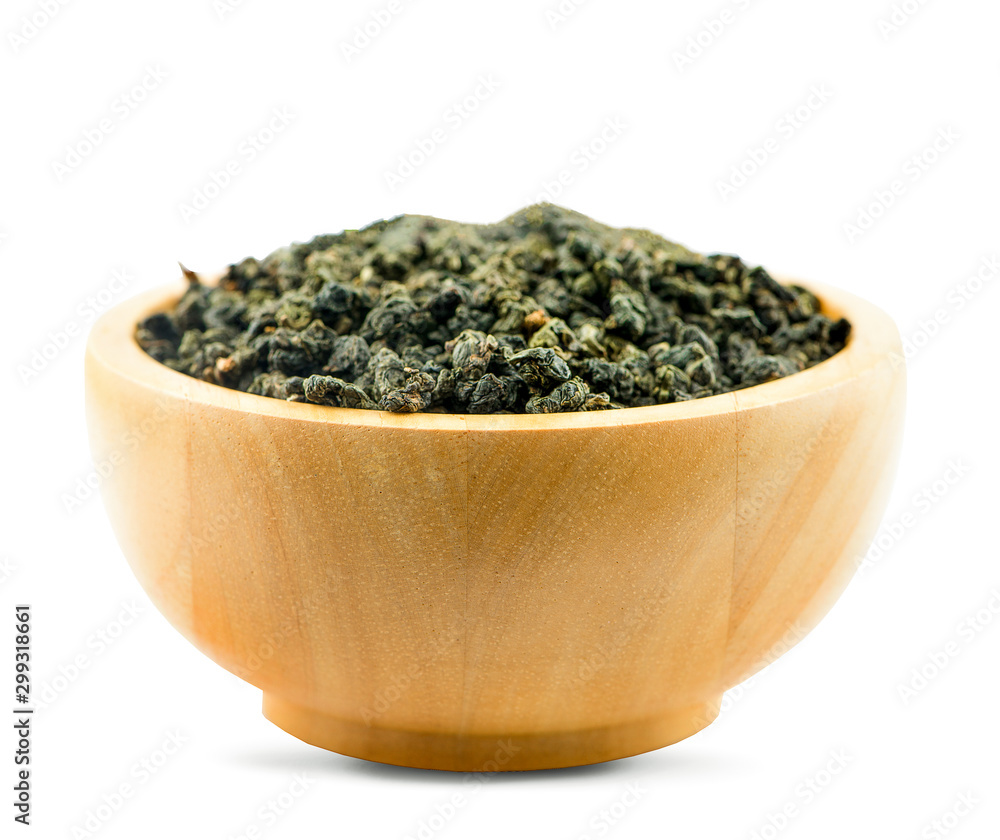 Dry green oolong tea in wooden bowl isolated on white background with clipping path Dry green oolong tea in wooden bowl isolated on white background with clipping path