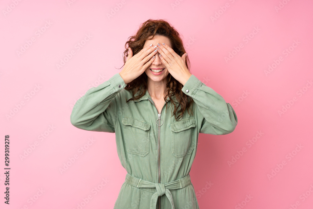 Young pretty woman over isolated pink background covering eyes by hands Young pretty woman over isolated pink background covering eyes by hands