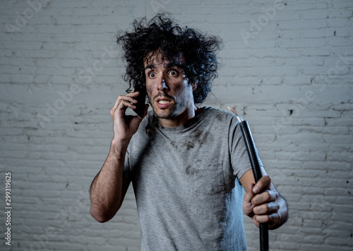Funny man holding burnt cable calling electrician for help. DIY repairs concept photo