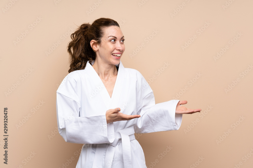 Young woman doing karate with surprise facial expression Young woman doing karate with surprise facial expression