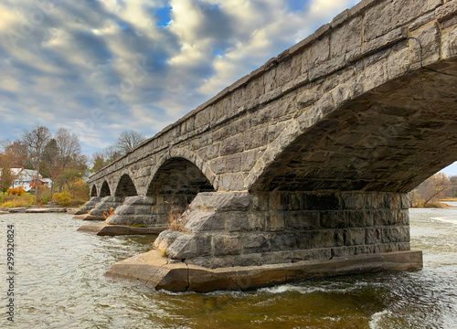 Pakenham Bridge, a five span stone bridge that crosses the Mississippi River on a cloudy autumn day in Pakenham, Canada