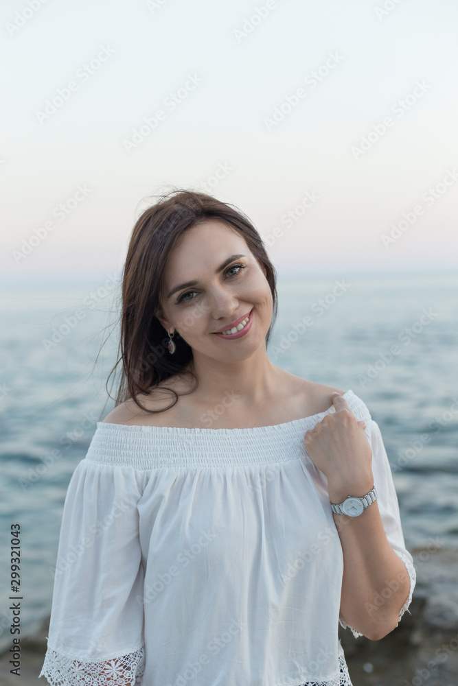 Portrait of a beautiful young woman by seaside Portrait of a beautiful young woman by seaside