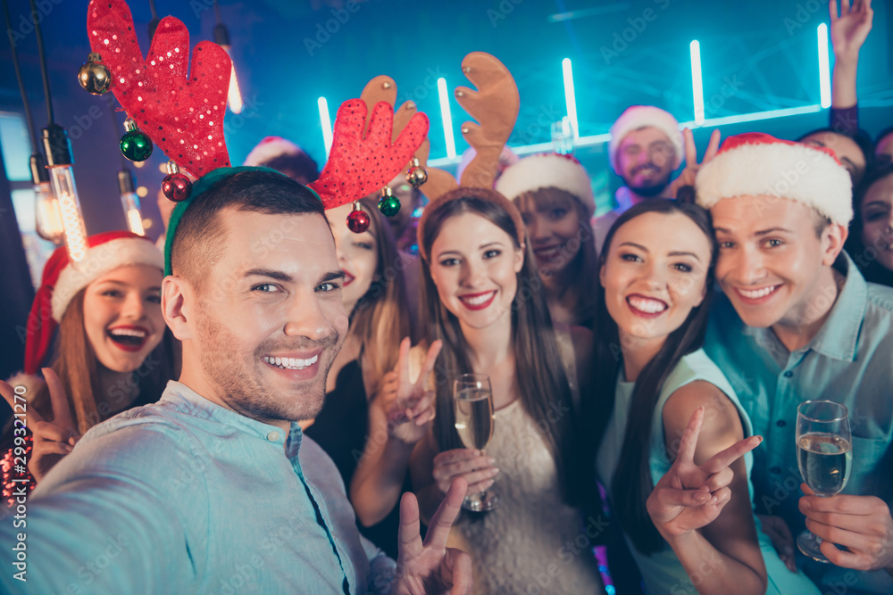 Close up photo portrait of positive carefree having good time at eve x-mas taking selfie blogger in santa claus hat raising glass sating toast for upcoming year 2020