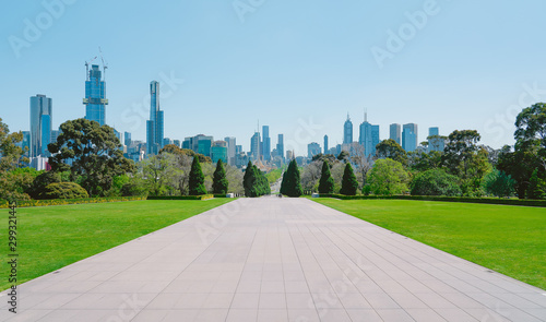 Melbourne cityscape view with empty cement floor and green grass . photo