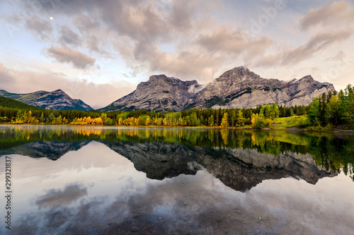 Canadian rockies with the moon reflection on Wedge pond in the morning at Kananaskis country