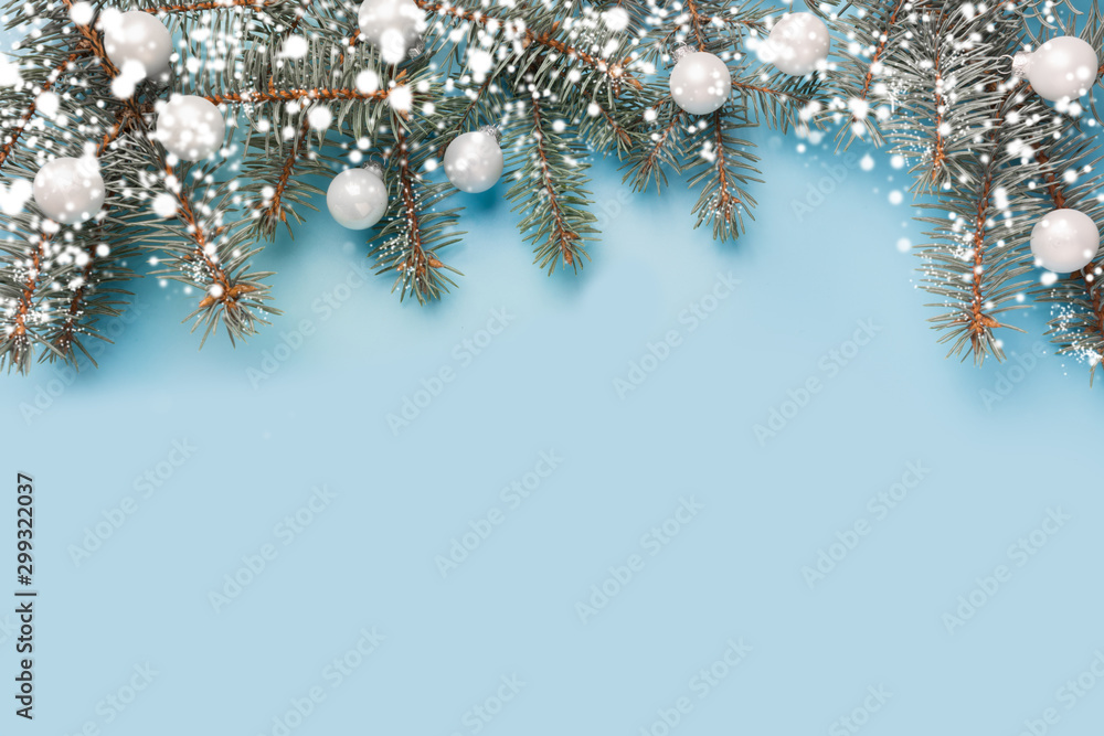 Christmas composition with fir branches tree, silver balls on pastel blue background. Merry Xmas card. Winter holiday. Happy New Year.
